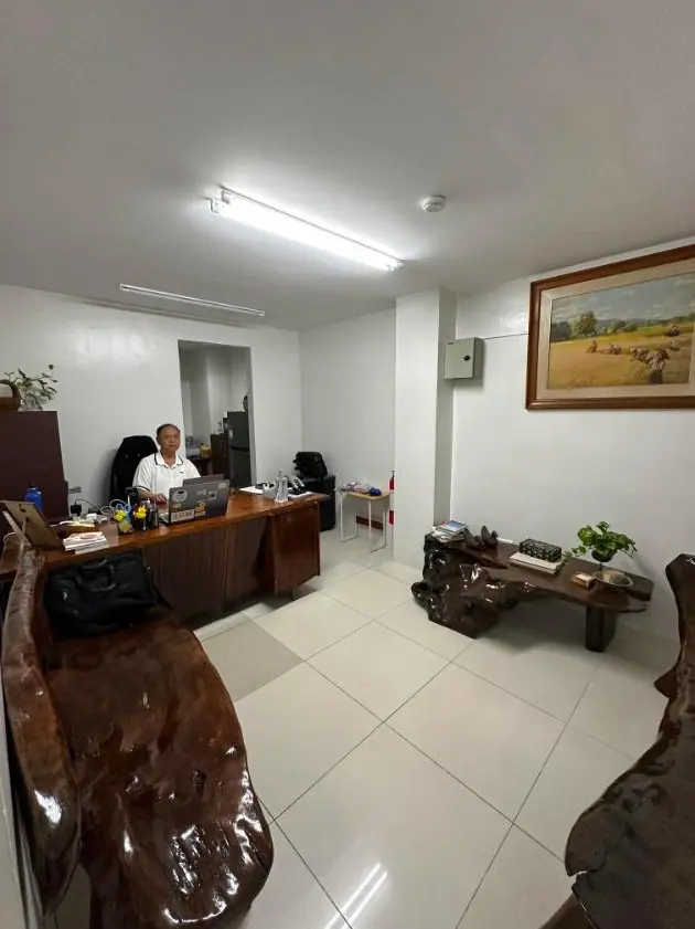 The General Manager's office, with a hardwood desk and carved wooden furniture