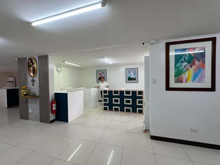 The employee support floor, with a navy and gold counter and open workstations beyond